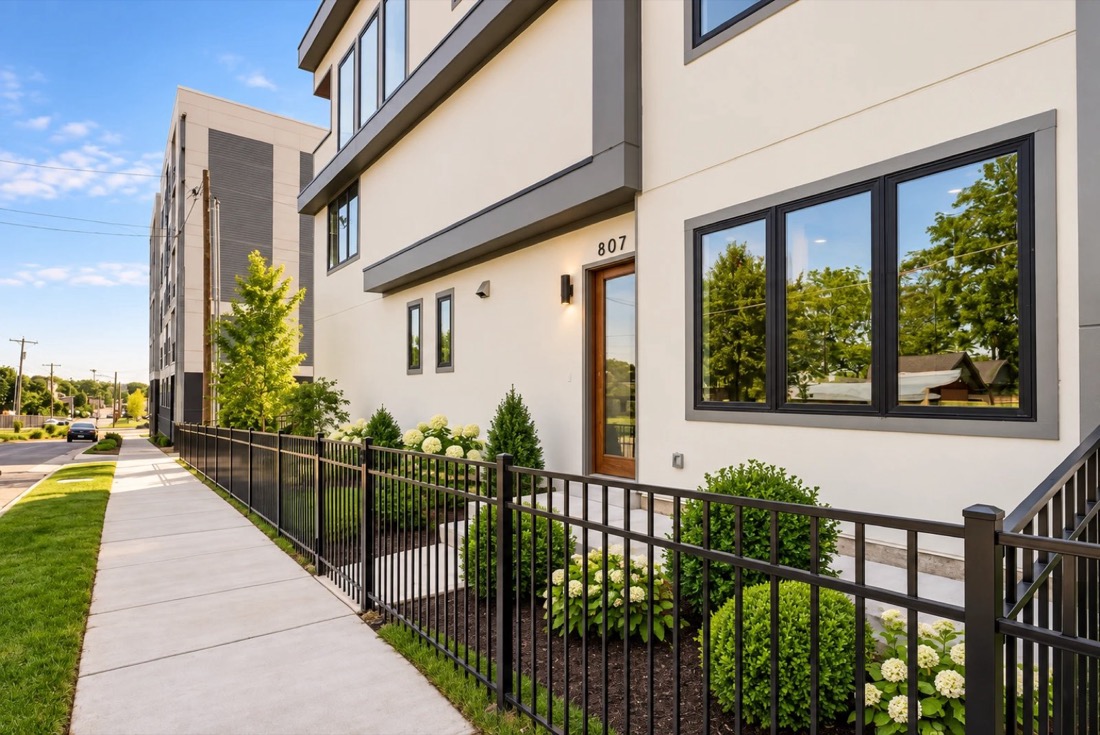 Modern white and gray townhome with black window frames