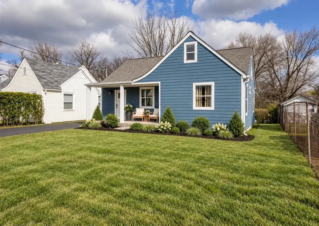 Blue lap-siding cottage with white trim and a covered porch