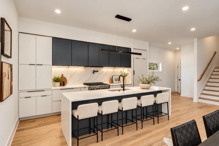 Kitchen with matte black upper cabinets and white island